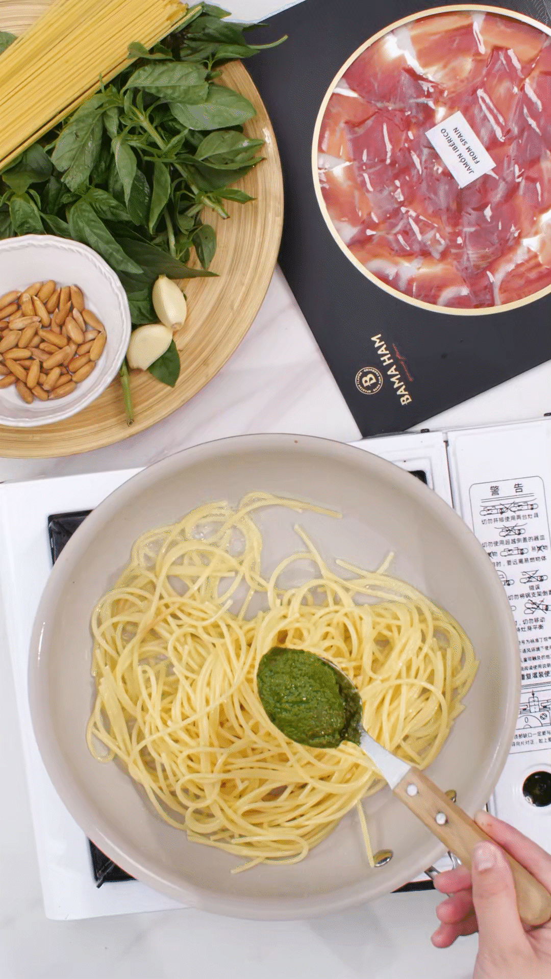 鍋中加入橄欖油，放入意面和青醬攪拌均勻裝盤(pán)
